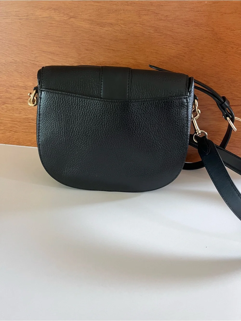 Coach Georgie crossbody saddle bag in black pebbled leather, gold tone hardware